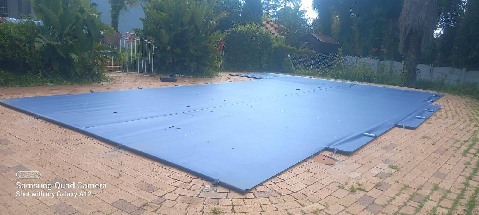 Bright blue pool cover installation at commercial property